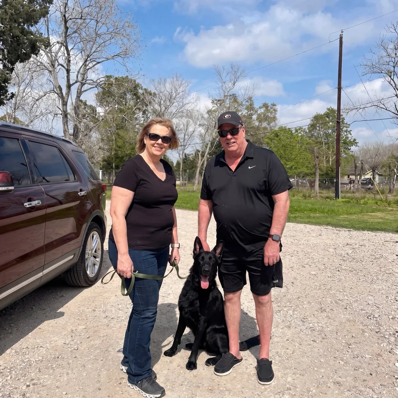 CJ's Dog Training clients with their trained dog